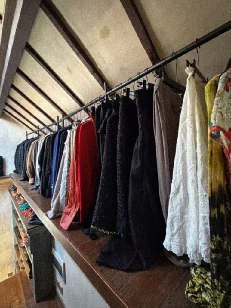 A row of textured garments on the upstairs archive rail.