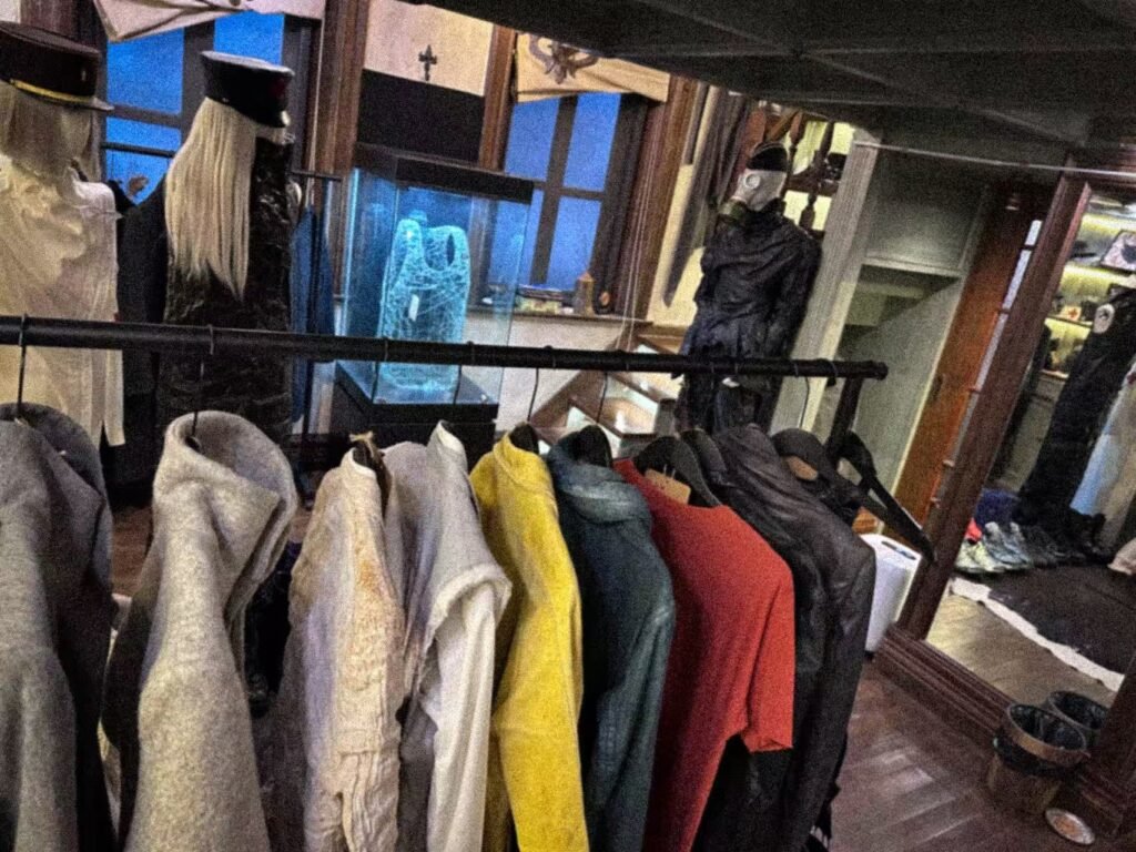 Coloured garments and a blue-lit display case inside SECTION.